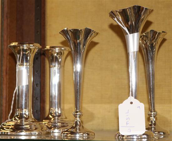 Three Edwardian silver specimen vases and a pair of plated candlesticks (loaded)